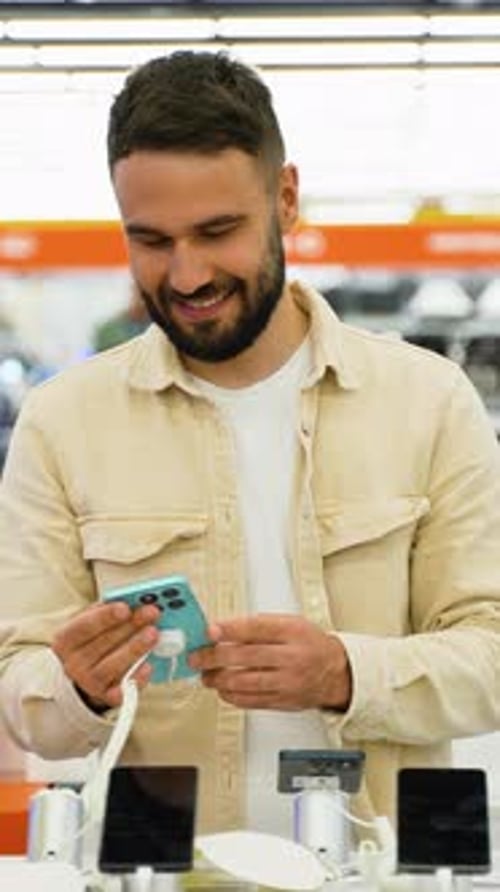 Customer Trying Out New Smartphone in Electronics Store