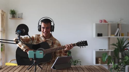 Man Plays Guitar and Streams from Home