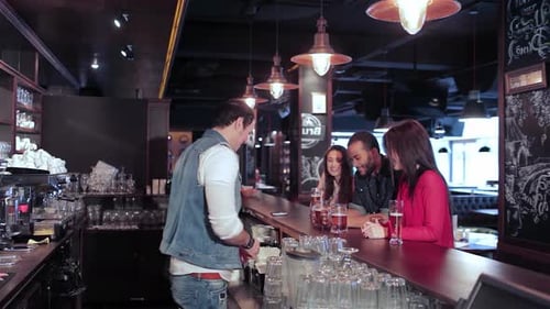 Bartender Serves Drinks to Friends at a Bar