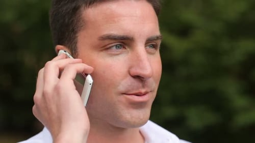 Handsome Man Smiling, Talking on Phone, Outside