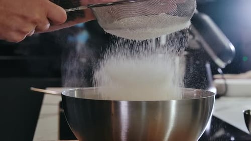 Flour Being Sieved into a Bowl Close Up