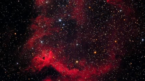 Red Nebula and Glowing Stars in Deep Space