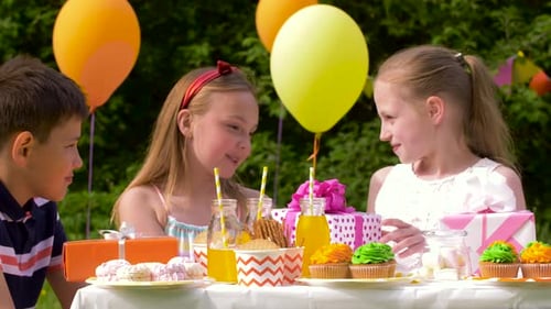 Children Enjoying Birthday Party in a Sunny Backyard