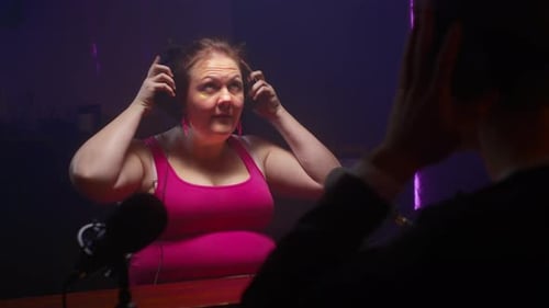 Woman Puts on Headphones Before Podcast Interview