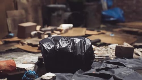 Close Up of a Black Garbage Bag in Abandoned Area