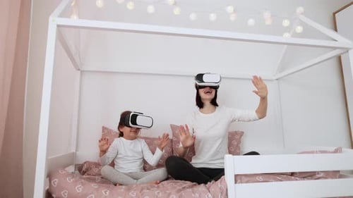 Mother and Daughter Using Virtual Reality Headsets