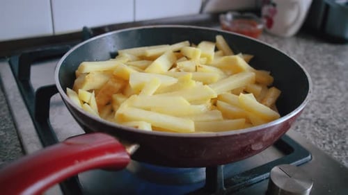 Potatoes are Fried in a Pan Cooking Dinner at Home