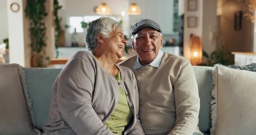 Old couple, laugh and face for conversation in home, support and speaking in lounge