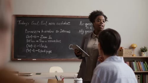 Woman Teaching a Class about Technology in Classroom