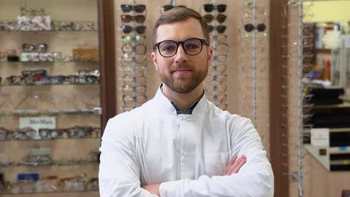 Attractive Young Doctor in Ophthalmology Clinic