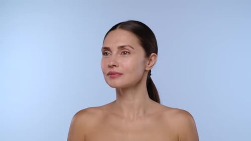 Woman Getting Face Injection on Light Blue Background