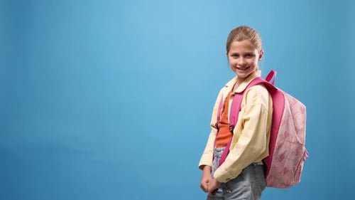 Smiling Schoolgirl with Pink Backpack Ready for School