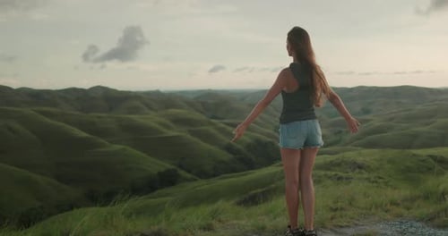 Woman Stand on Green Hill Meadow Raised Hands