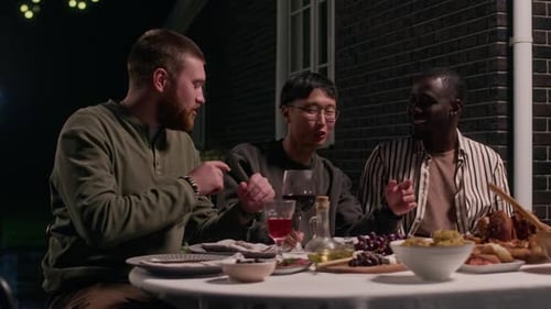 Friends Enjoying an Outdoor Evening Meal Together