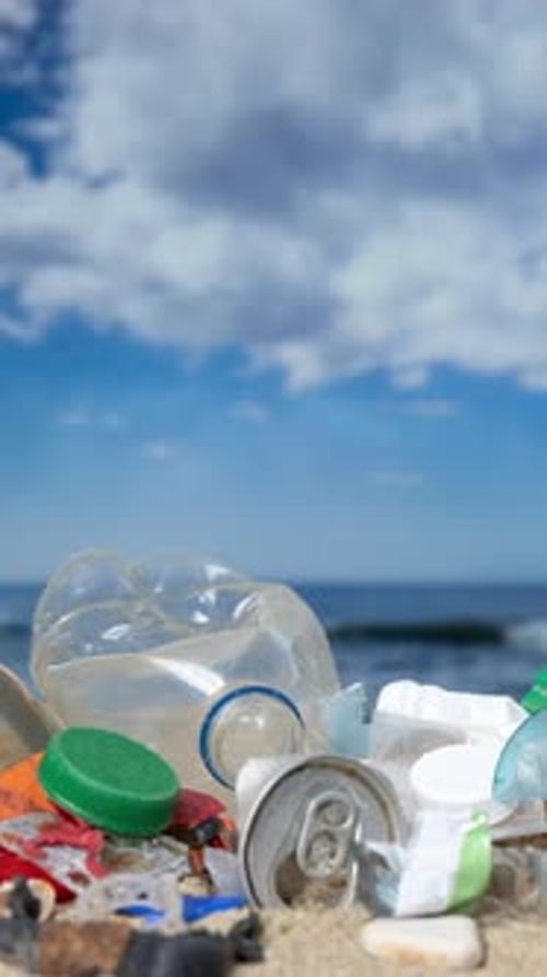 Plastic Rubbish and Waste Items on a Beach in Vertical Format