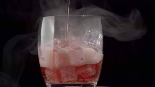 Red Liquid Poured Over Ice in Glass