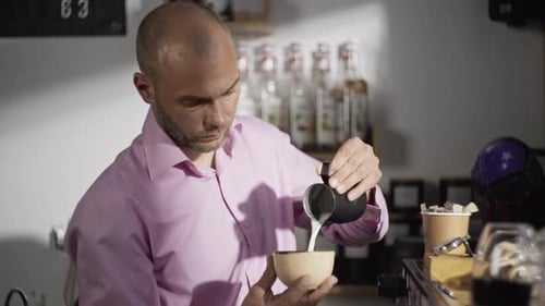 Barista Pouring Milk Into Coffee Cup