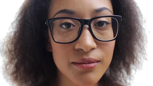 Smiling young woman with eyeglasses portrait close up