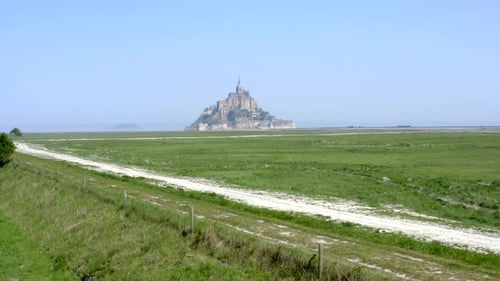 Revealing shoot of Mont Saint-Michel staring the clip from old road in nearby area.