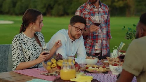Friends Enjoying Meal and Wine Outdoors