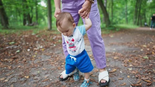 Baby Taking First Steps in Green Park