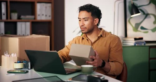 Man Preparing Package for Shipping in Office Setting