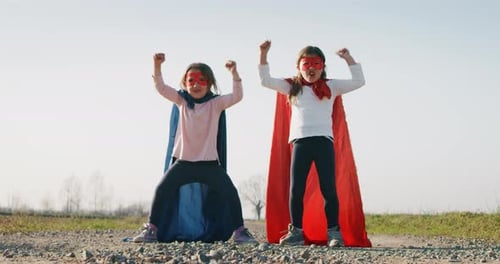 Girls Dressed as Superheroes Posing in Field