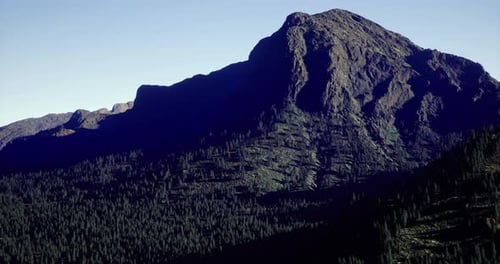 Majestic Mountain Landscape with Dense Forest During Bright Daylight Hours