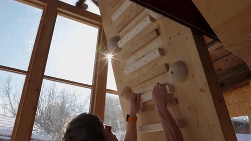 Climber training on the Campusboard in Winter in Homegym