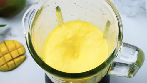Mango smoothie mixing in blender for healthy drink