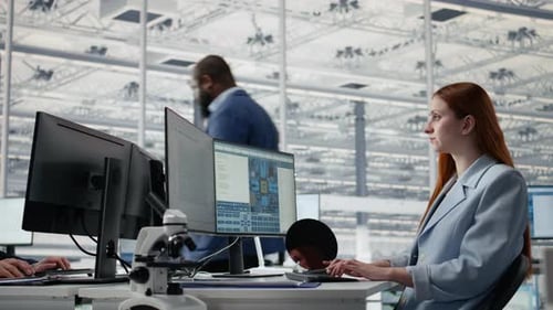 Reviewing Microchip Production Operations PC Software and Man with Woman