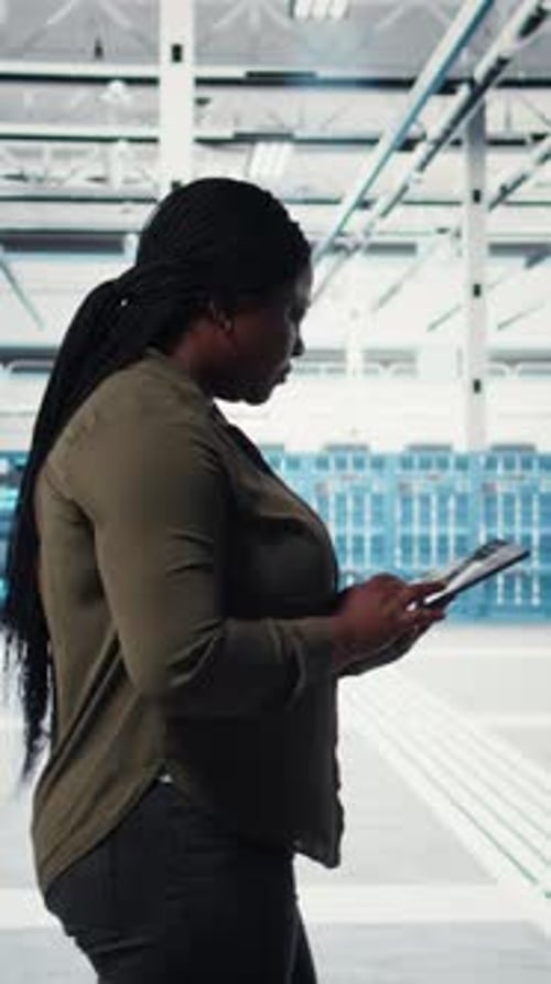 Vertical Video Smiling Engineer Walking in Data Center with Laptop Checking Hardware