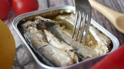 Canned Fish Lifted by Fork with Tomatoes