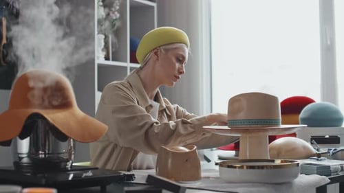 Woman Milliner Designing and Steaming Hats in Studio