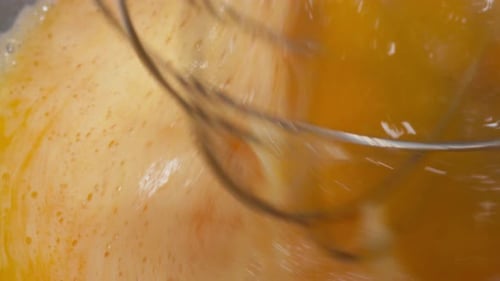 A Cooker Mixing Eggs with Flour in Bowl Kneading the Dough Process of Pastry Production Mixer