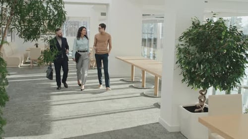 Business People Walking along Office Corridor