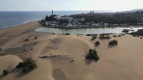 Amazing aerial views of the Gran Canaria island Maspalomas dunes in Spain. City by the desert.