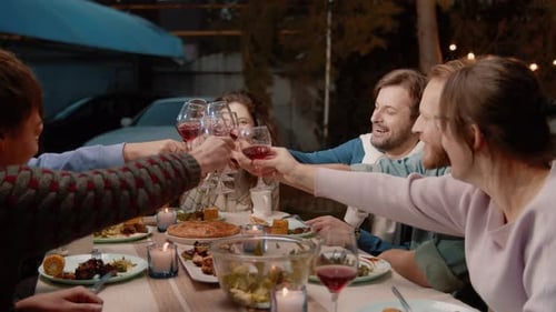 Friends Together Enjoying Dinner Party Outdoors at Night