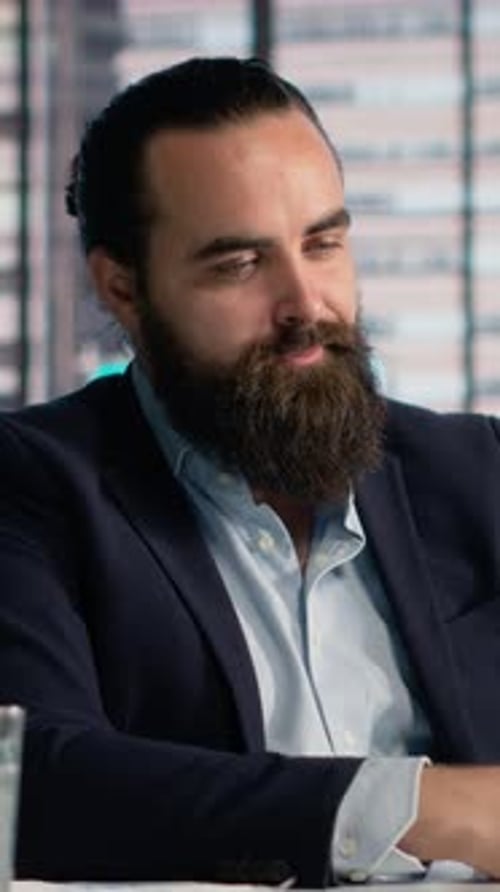 Bearded Man in Blazer Talking in Office Meeting