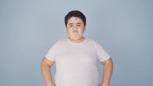Boy looking depressed at camera.