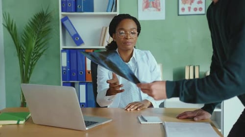 Doctor Explains X-ray Results to Male Patient