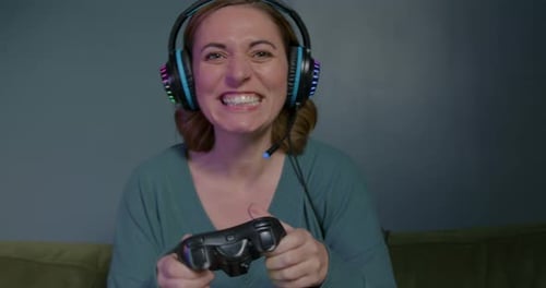 Woman Playing Video Games with Headphones Indoors