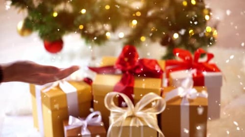 Christmas gifts are exchanged as snow falls indoors