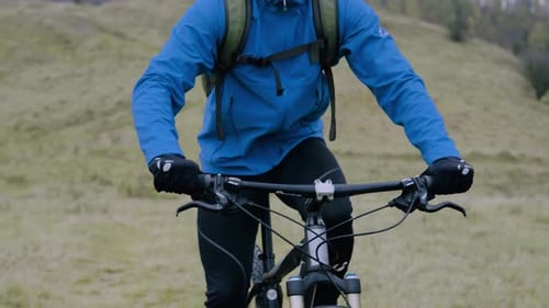 Young Man Mountain Biking on Overcast Day