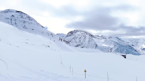 Aerial view of snow-covered Alpine mountains, showcasing expansive ski slopes, winter landscapes
