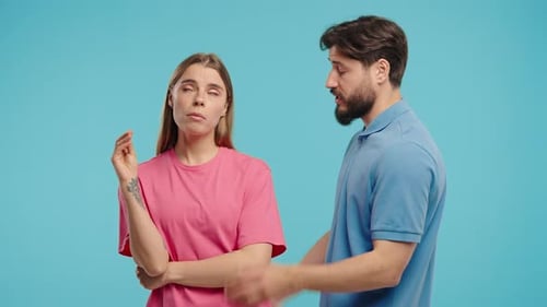 Man and Woman Arguing on Blue Background