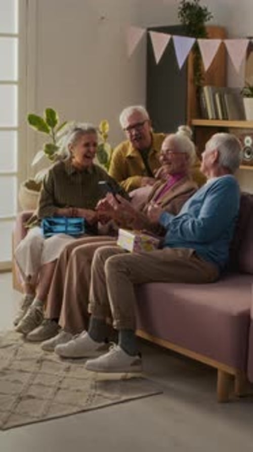 Seniors Gather on Sofa for Birthday Celebration