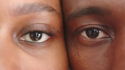 Close-up of young couple's eyes, showing intimacy and connection at home
