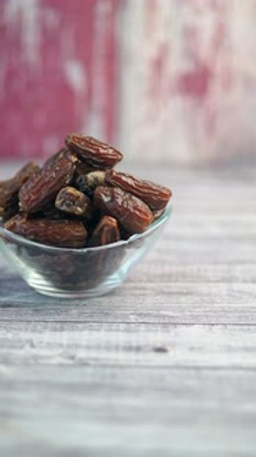 Dates in bowl still life on wood table