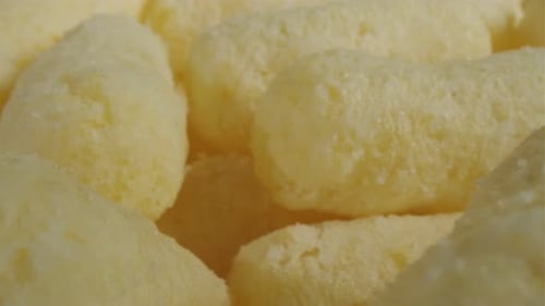 Close Up of Yellow Air Corn Sticks Closeup Crunchy Corn Snacks Texture Selective Focus